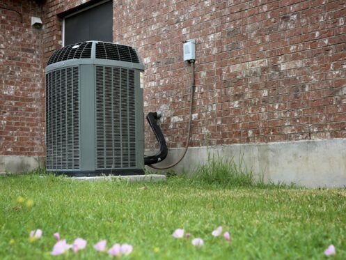 High efficiency modern AC-heater unit on brick wall background