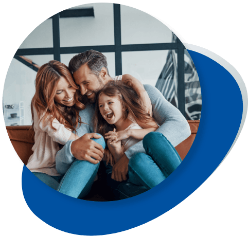 Cute family of 3 hugging on the couch