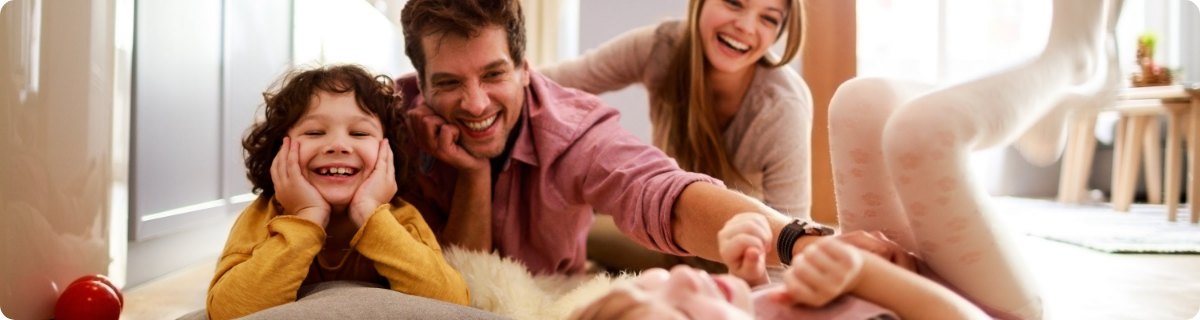 cute family laughing on the floor