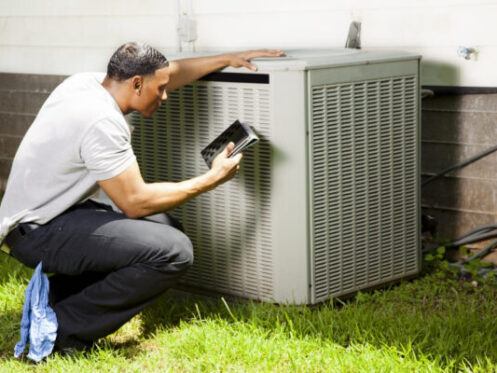 Homeowner Examining HVAC unit before HVAC Maintenance in Tolleson, AZ